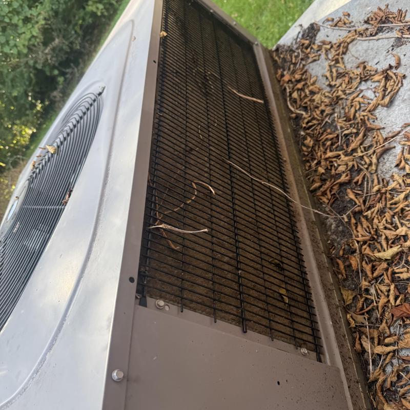 Air conditioner condenser coil clogged with debris outdoors Air conditioner condenser coil clogged with debris outdoors