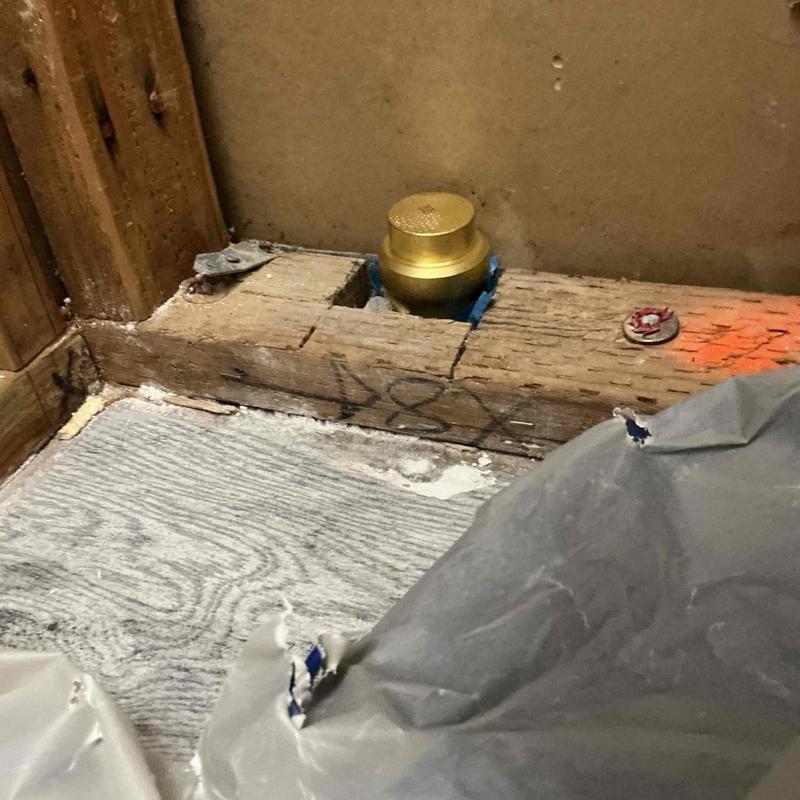 PEX water line with brass cap inside wall cavity