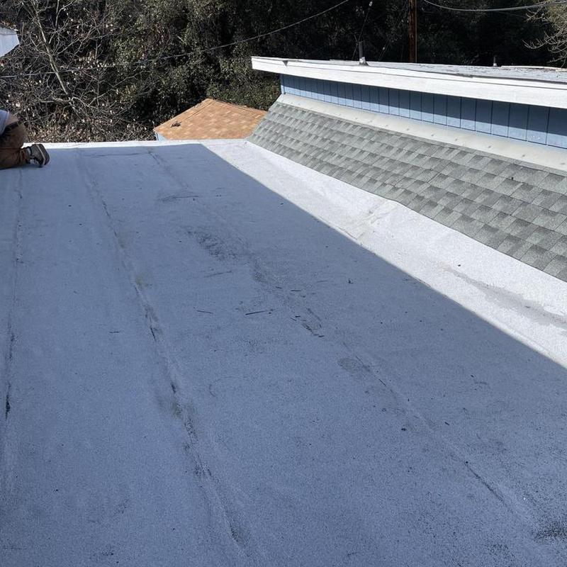 Torch down low pitch roof with adjacent asphalt shingles