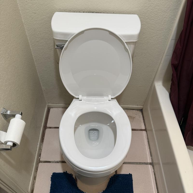 White two-piece toilet with open lid and seat