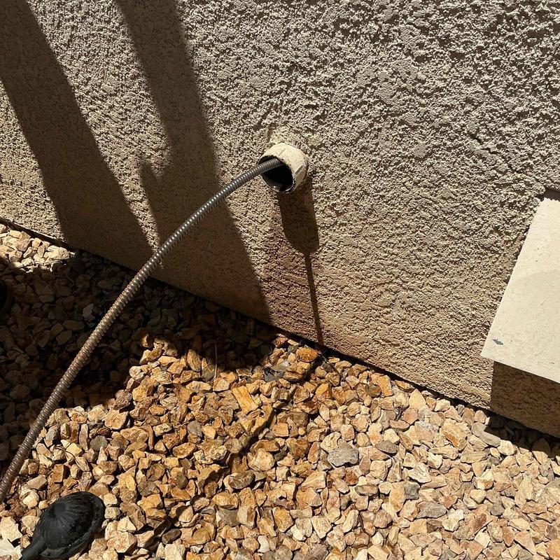 Kitchen mainline drain snake inserted through cleanout pipe
