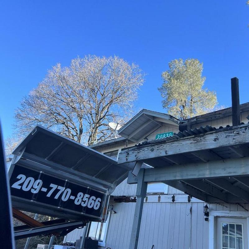Asphalt shingle roof replacement on cabin porch