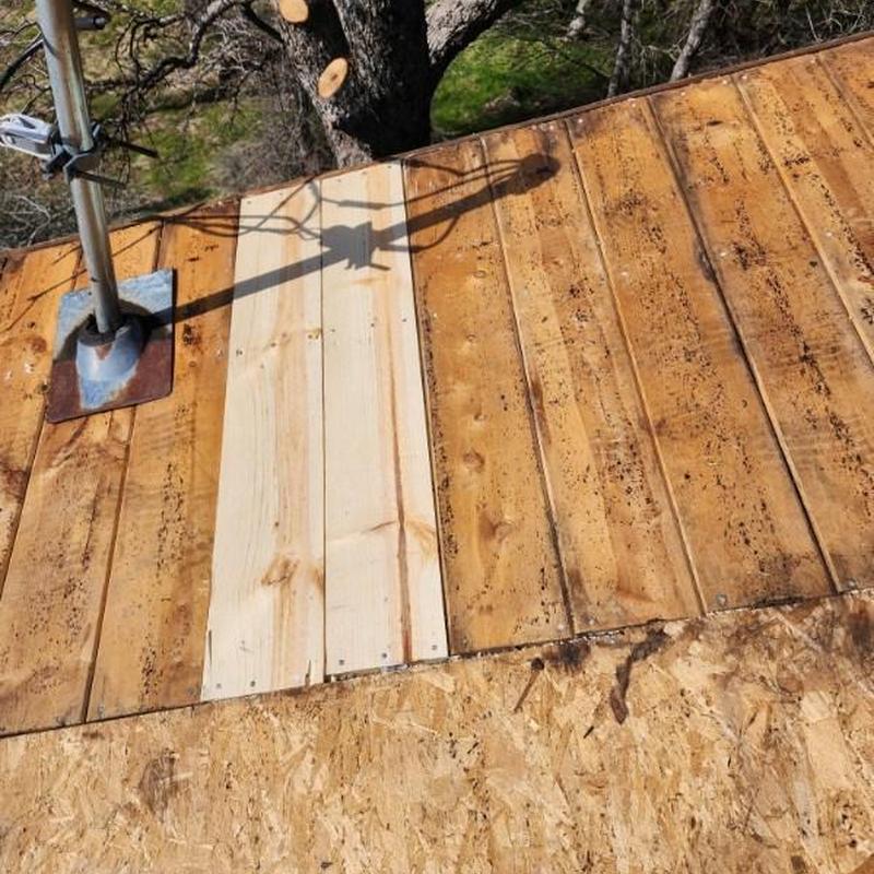 Wood roof decking replacement on cabin roof section