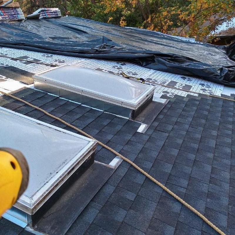 Asphalt shingle roof with skylight installation