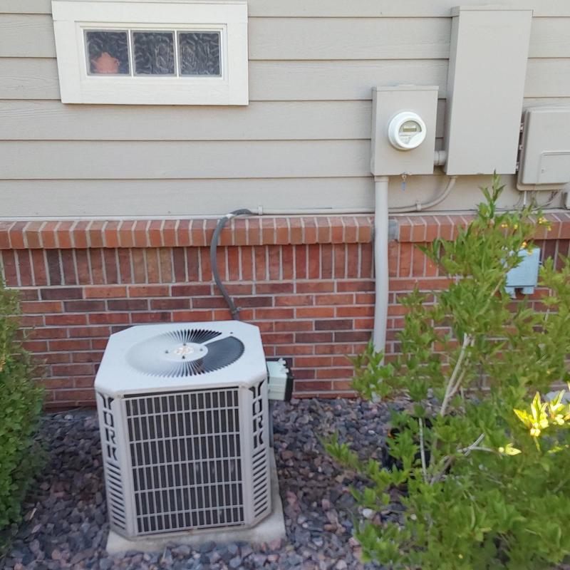 York air conditioner unit outside brick wall