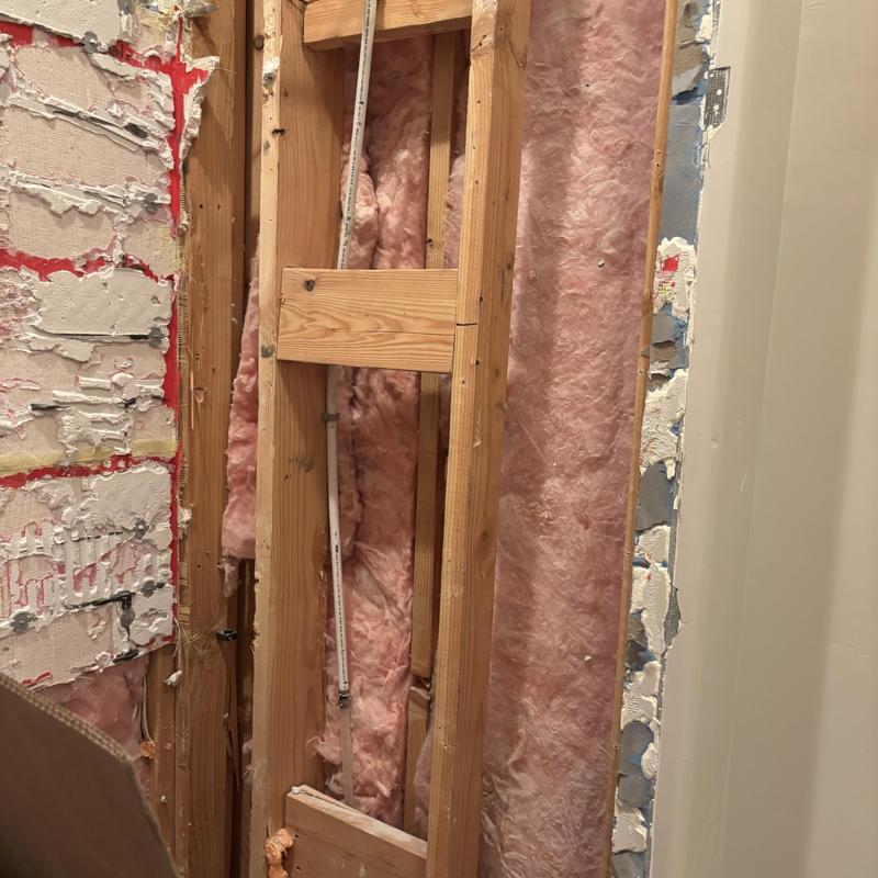 Tub-shower combo removal with exposed wall studs and insulation Tub-shower combo removal with exposed wall studs and insulation