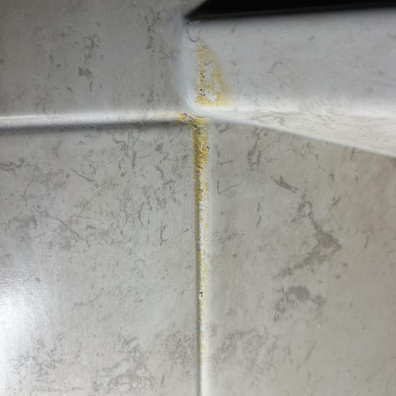 Shower enclosure mildew buildup with old sealant Shower enclosure mildew buildup with old sealant