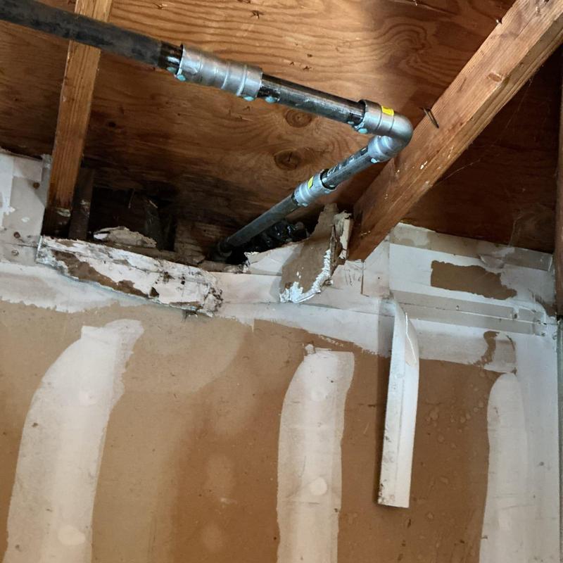 Galvanized pipe with Mega Press connector in ceiling joists
