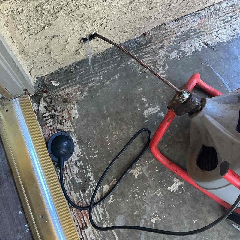 Kitchen branch drain line clearing tool in use