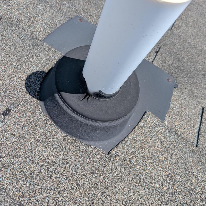 Roof vent pipe flashing with cracked sealant on shingles