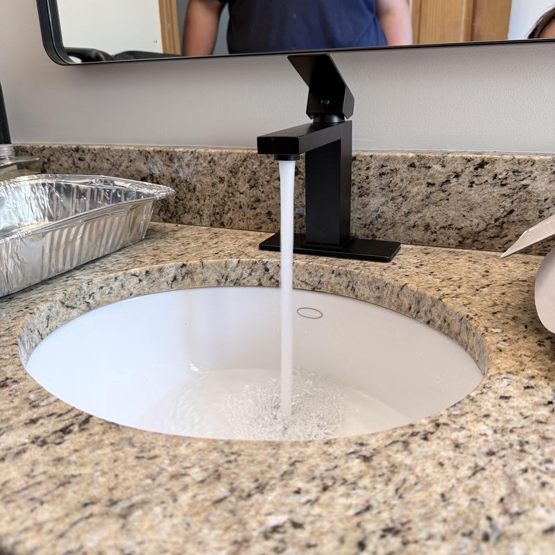 Black bathroom faucet with water running Black bathroom faucet with water running