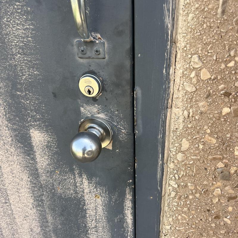 Door knob and deadbolt lock on metal door