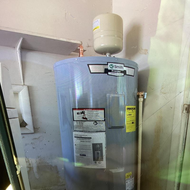 Electric water heater with expansion tank installed Electric water heater with expansion tank installed