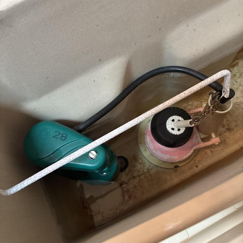Toilet fill valve and flapper inside tank