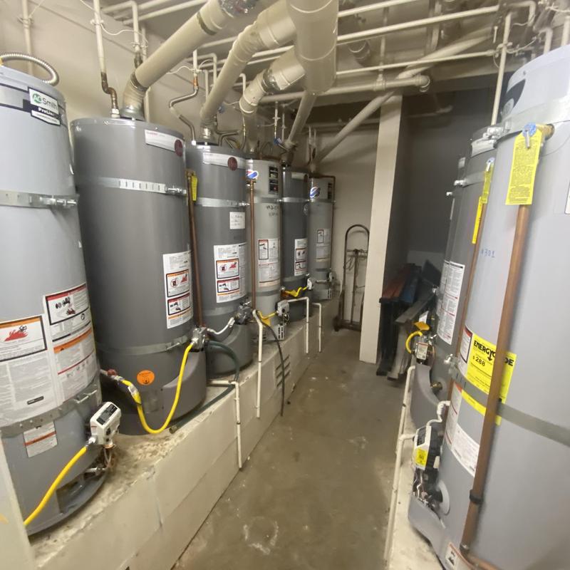 Water heater system with multiple tanks in utility room