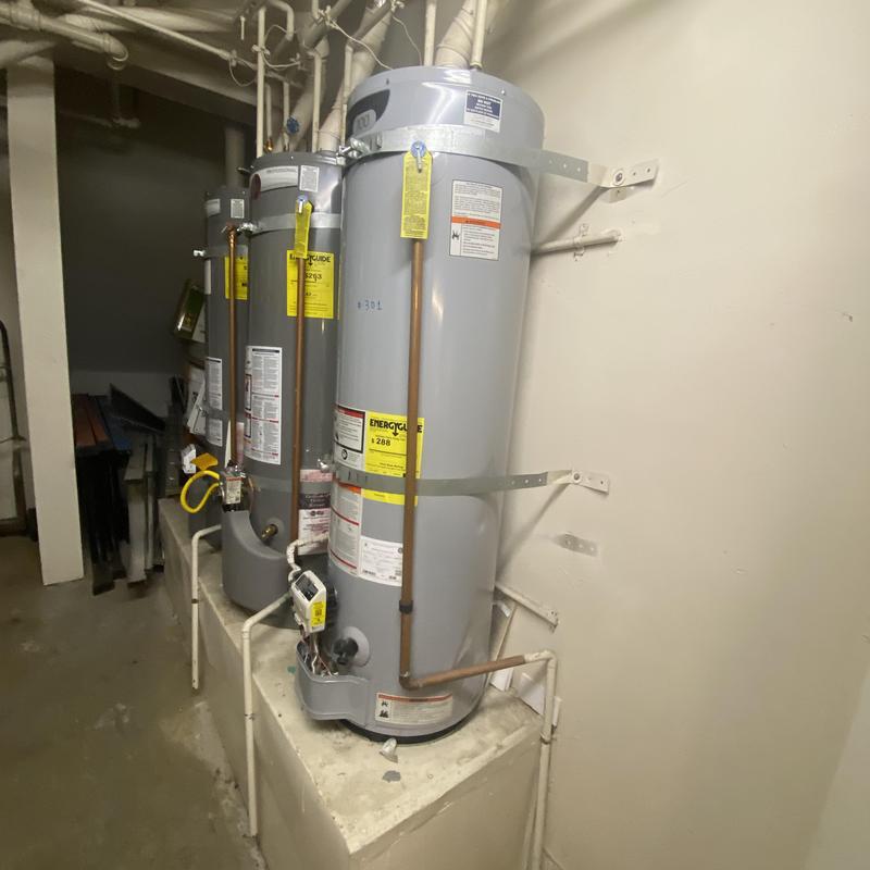 Water heater tanks with piping in basement