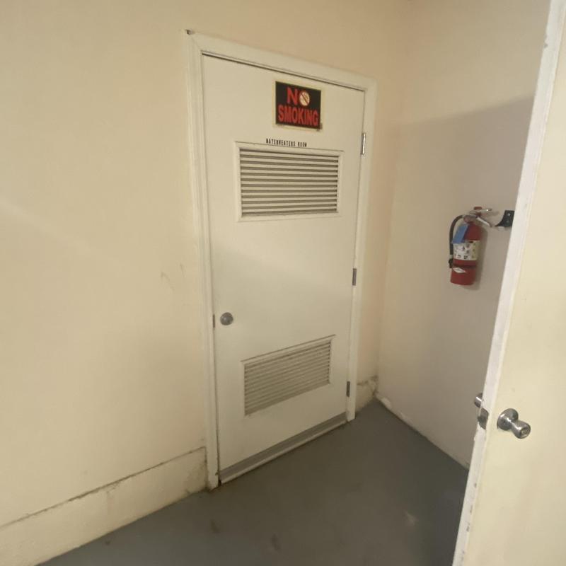 Water heater room door with vent and fire extinguisher