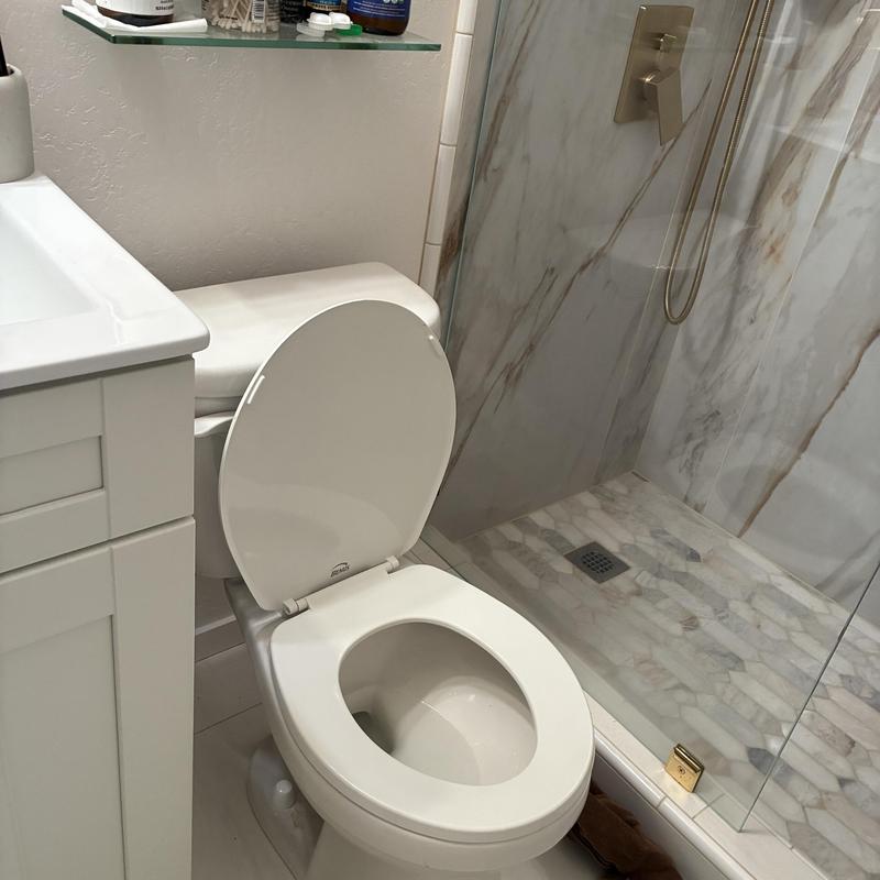 Toilet with new wax rings reset in bathroom