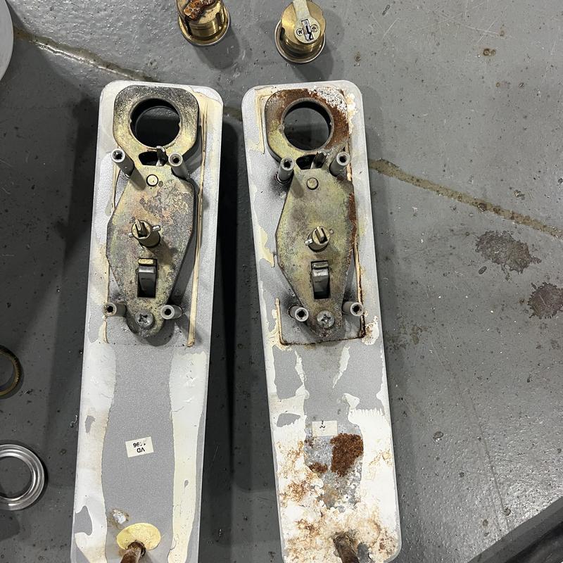 Door lock mounting plates with rust and parts removed