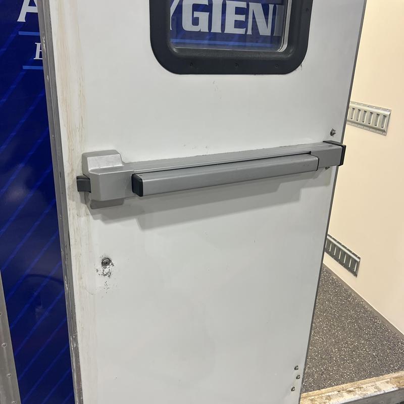 Panic bar exit device on white commercial door