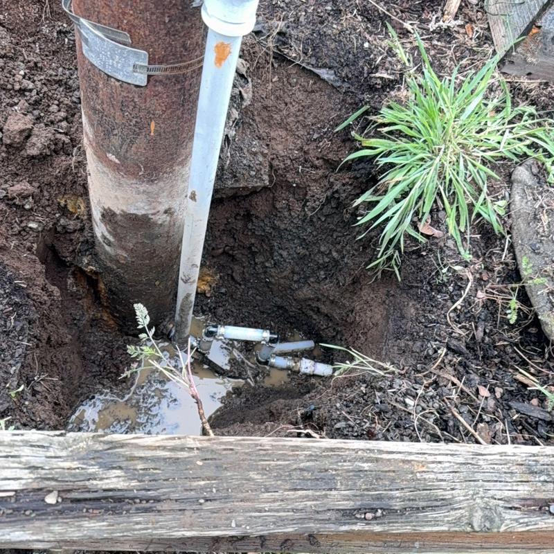 Water service piping repair in muddy excavation site Water service piping repair in muddy excavation site
