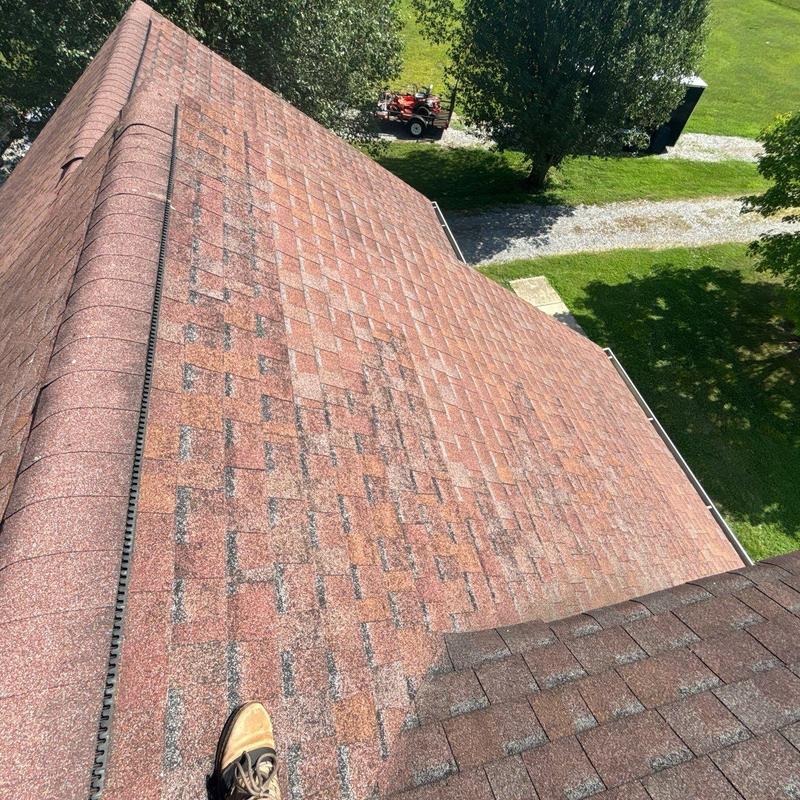 Asphalt shingle roof with severe granule loss on slope