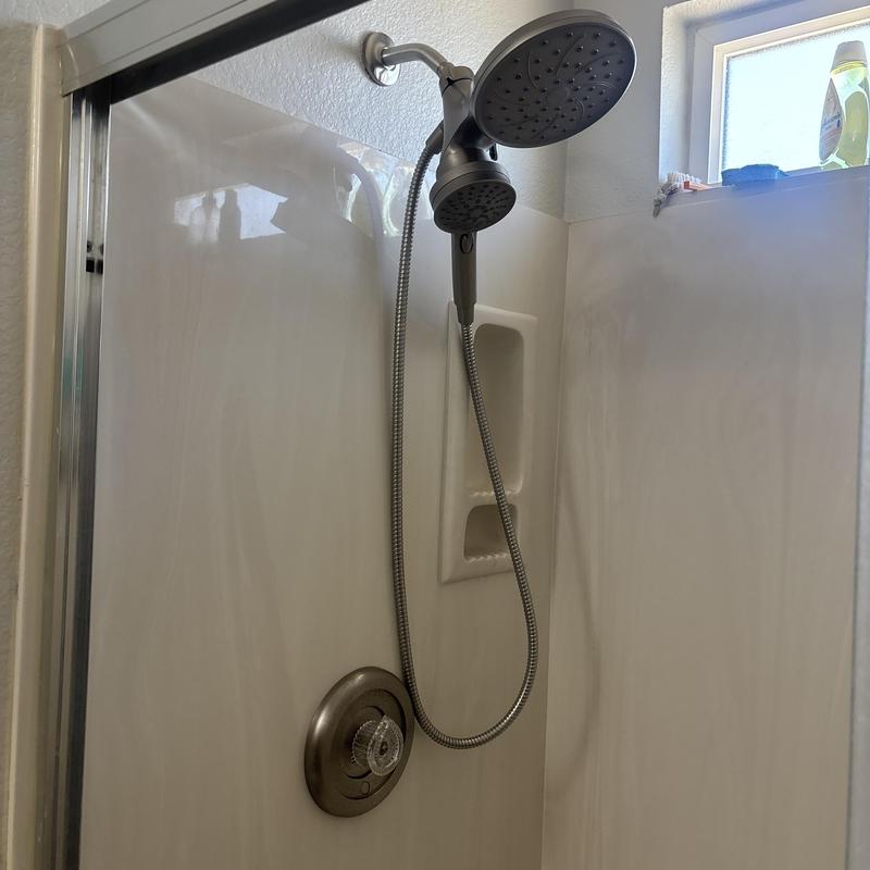 Showerhead and handheld shower installation in bathroom