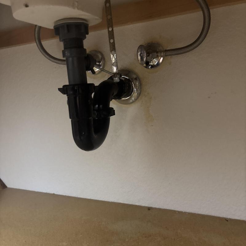 Lavatory sink P-trap with water supply lines under cabinet