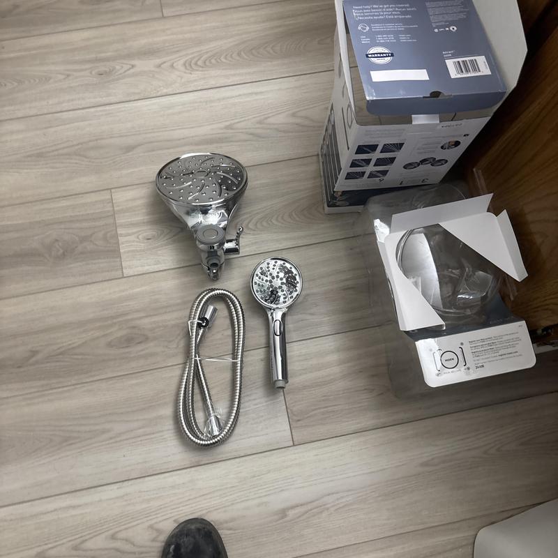 Showerhead set with hose and handheld sprayer on floor