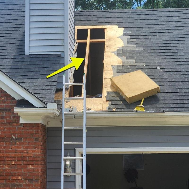 Chimney roof framing exposed with ladder and removed shingles