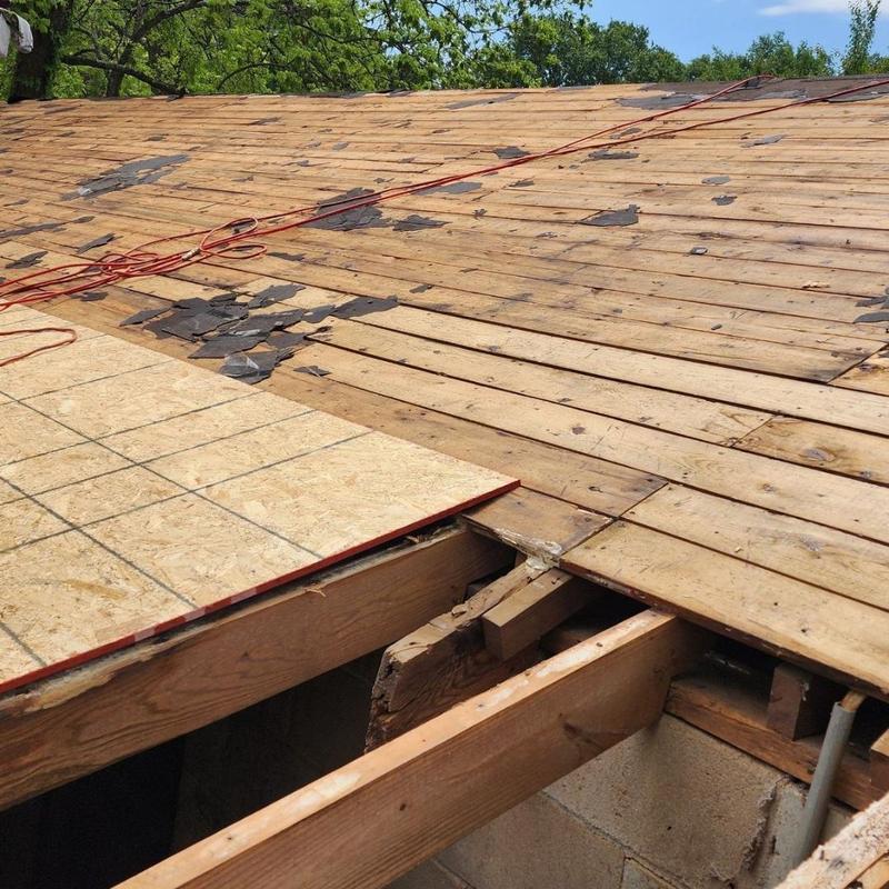 Barn roof decking with damaged wooden boards