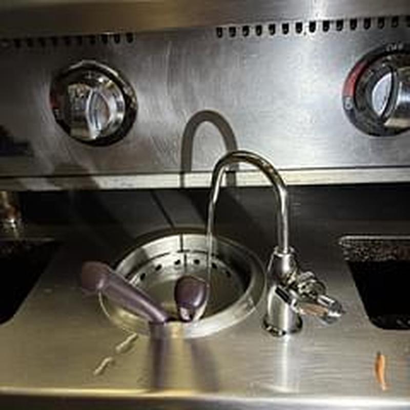 Dipper well faucet with running water on stainless sink Dipper well faucet with running water on stainless sink