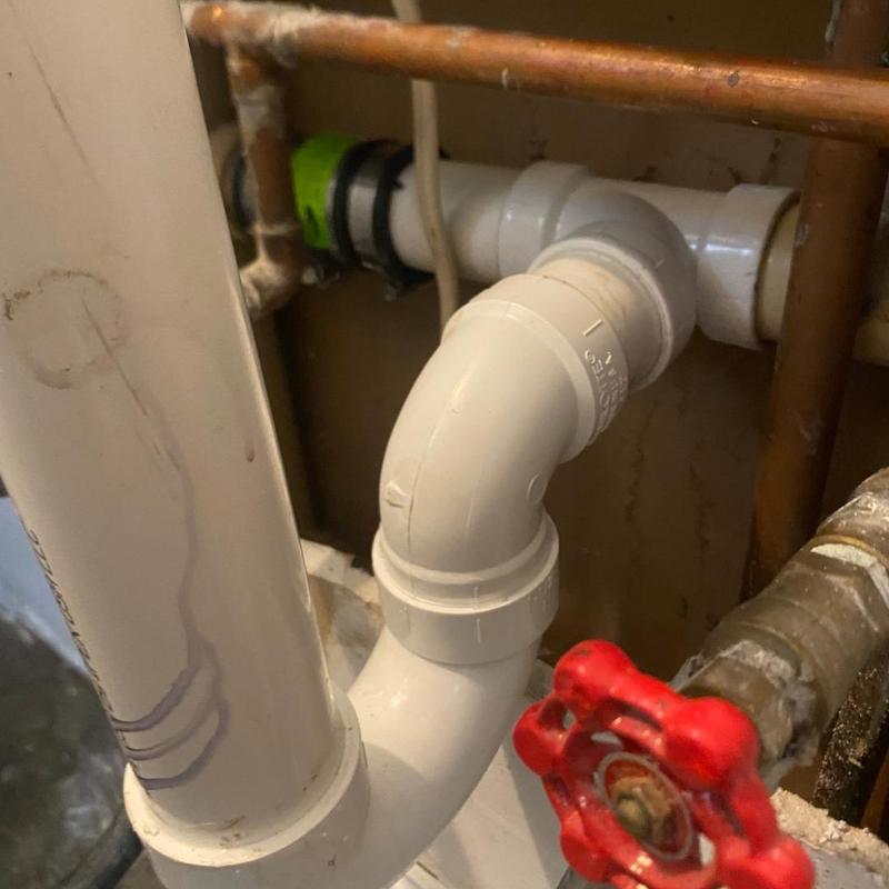 Kitchen drain PVC piping with red valve handle