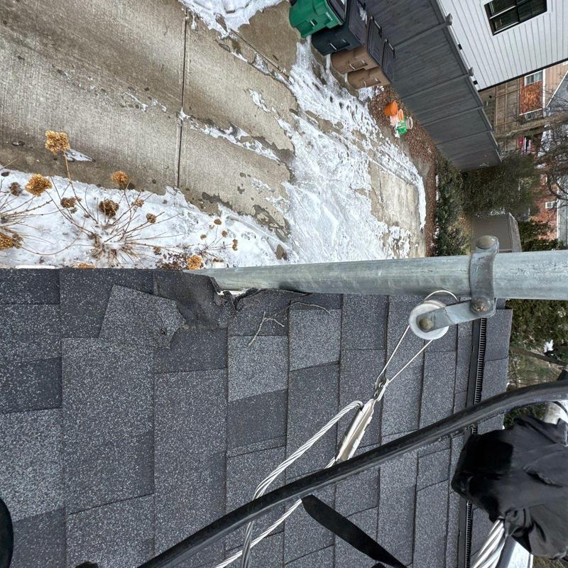 Asphalt shingles with hail damage near flashing