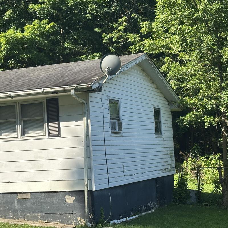 Old residential roof with worn shingles and gutter system Old residential roof with worn shingles and gutter system