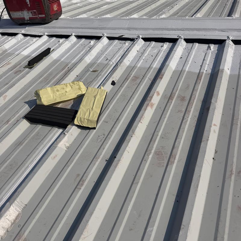 Metal roof ridge closure installation materials on panels