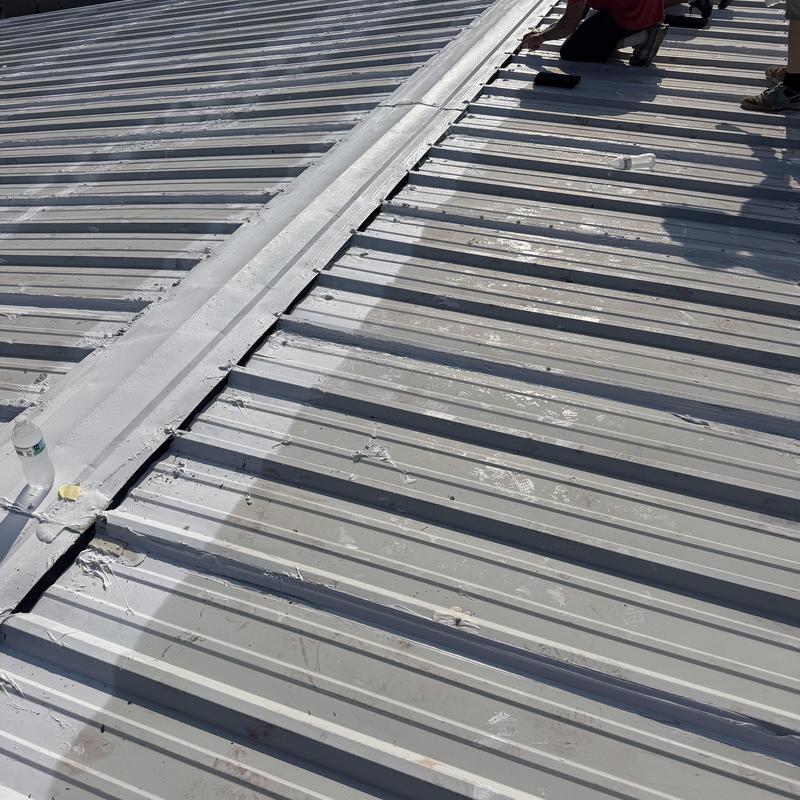 Metal roof ridge cap with closure installation in Pearl, MS
