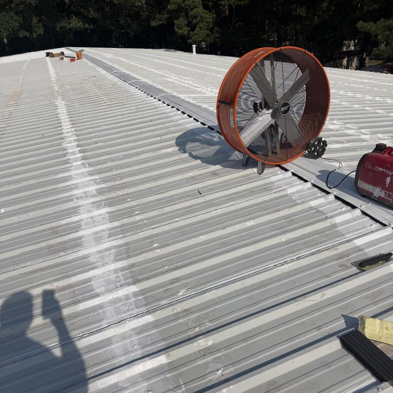 Metal roof panel seam sealing with ventilation fan and generator