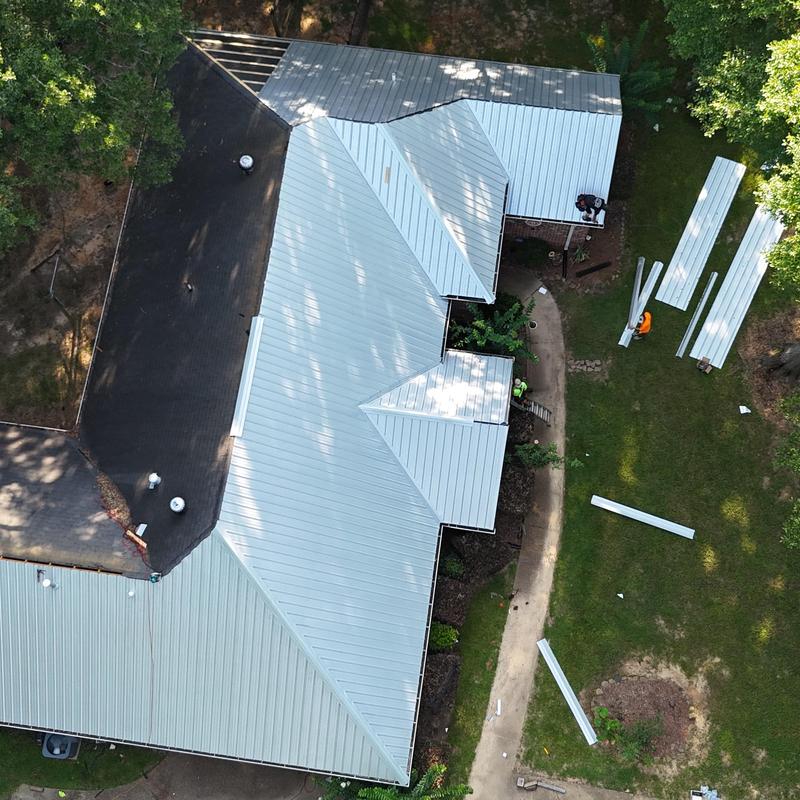 Metal roof panels installation on residential house