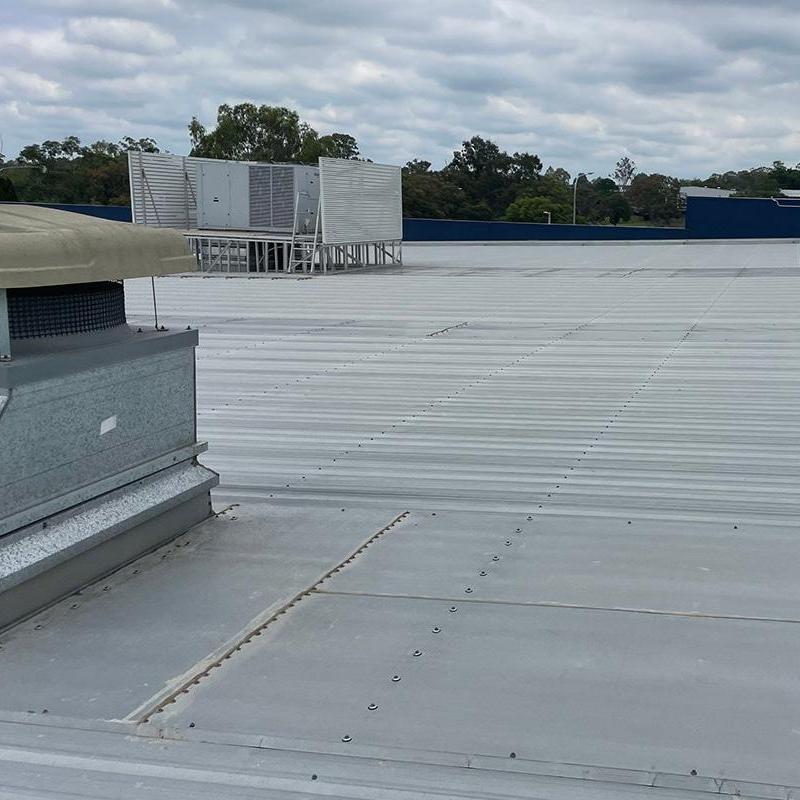 Commercial metal roof with HVAC units and vents Commercial metal roof with HVAC units and vents