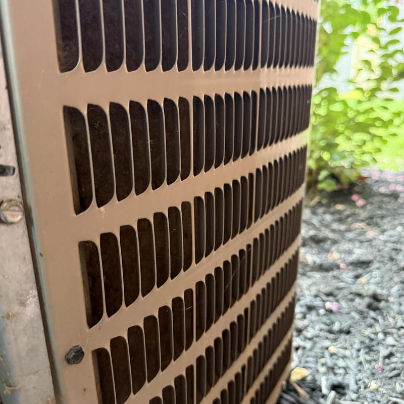 Outdoor HVAC unit condenser coil grille close-up Outdoor HVAC unit condenser coil grille close-up
