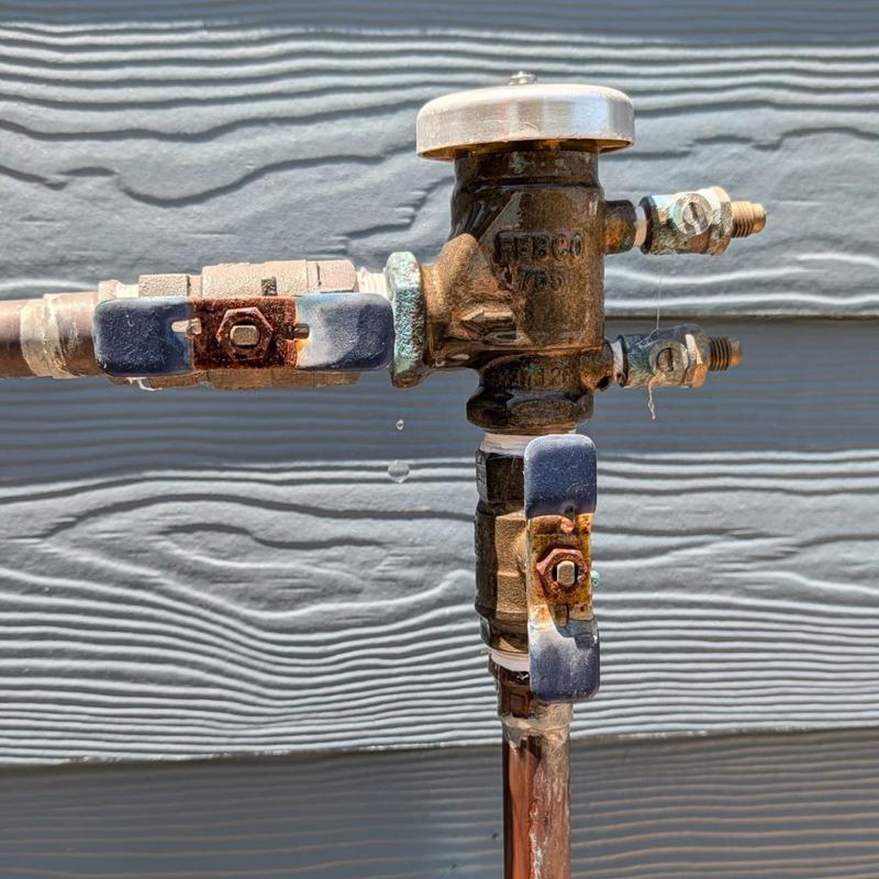 Vacuum breaker valve with rusted handles on plumbing line Vacuum breaker valve with rusted handles on plumbing line