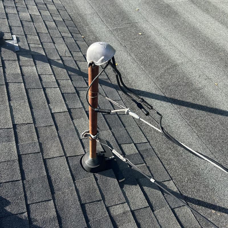 Overhead electrical service riser with code violations on roof Overhead electrical service riser with code violations on roof