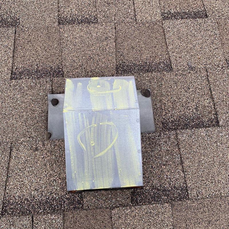 Roof vent with hail damage markings on shingles