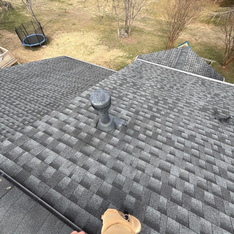 Roof shingles with ventilation pipe and hail damage