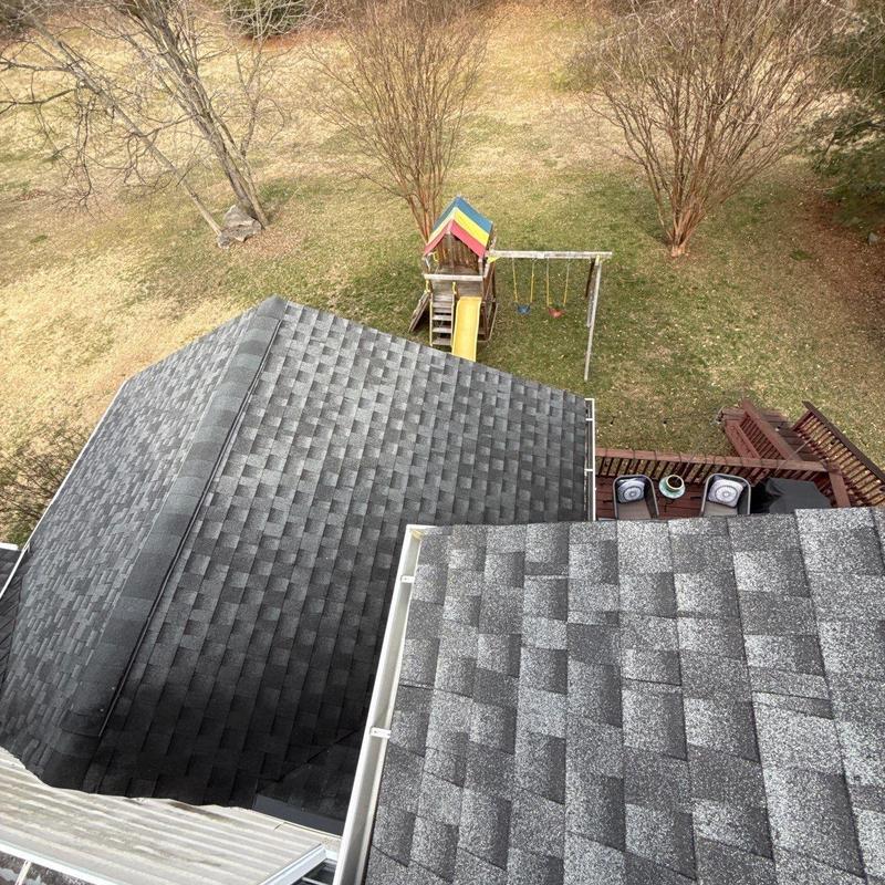 Shingle roof with hail damage inspection and playset nearby