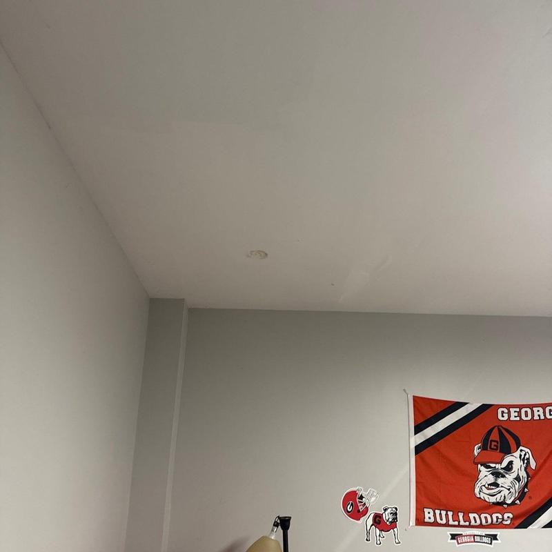 Ceiling drywall with water damage near corner wall