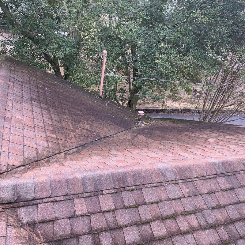 Asphalt shingle roof with hail damage and debris