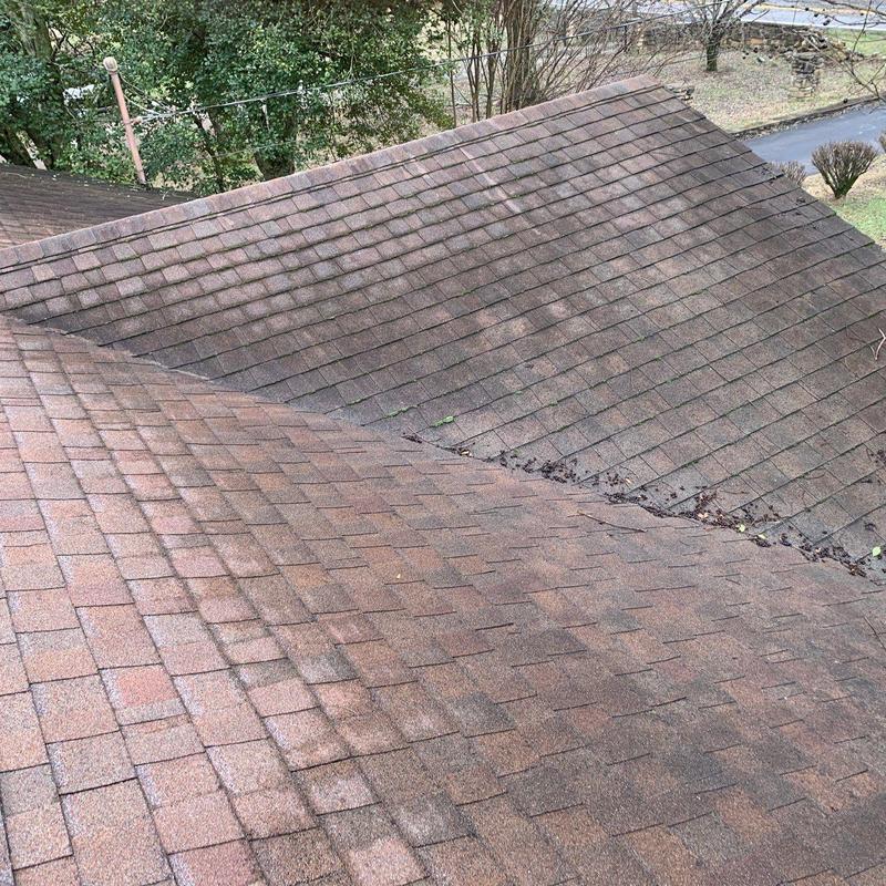 Asphalt shingle roof with hail damage and debris buildup