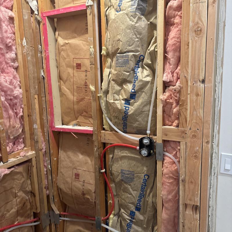Shower valve rough-in with PEX piping in wall studs